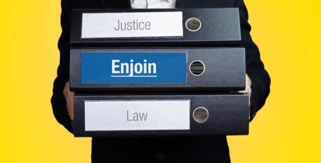 Enjoin – Lawyer carries a stack of 3 file folders. One folder has the label Enjoin. Symbol for law, justice, judgement
