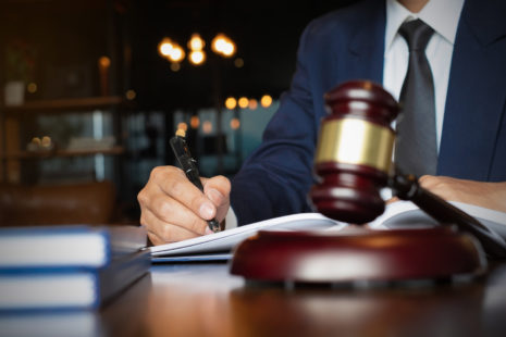 Close up lawyer businessman working or reading lawbook in office workplace for consultant lawyer