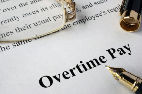 Overtime pay concept written on a paper.