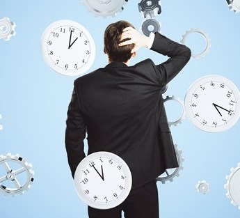 Man scratching his head looking at floating clocks.