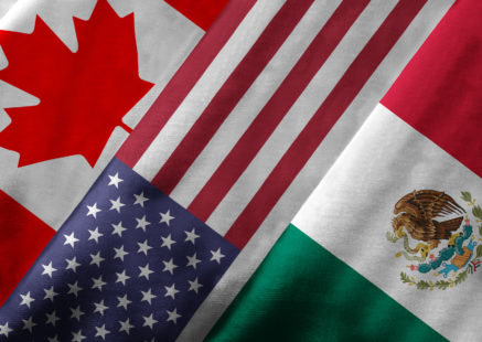 Close up of the flags of the North American Free Trade Agreement NAFTA members on textile texture. NAFTA is the world's largest trade bloc and the member countries are Canada, United States and Mexico.