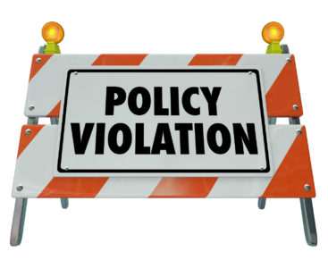 Policy Violation words on a road construction barrier or sign warning you of a rule or regulation that has been broken or violated