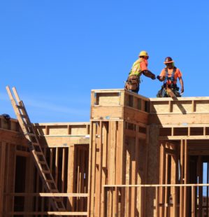 Construction workers building a house