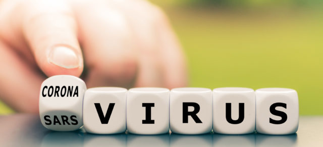 Hand turns a dice and changes the expression "sars virus" to "corona virus".