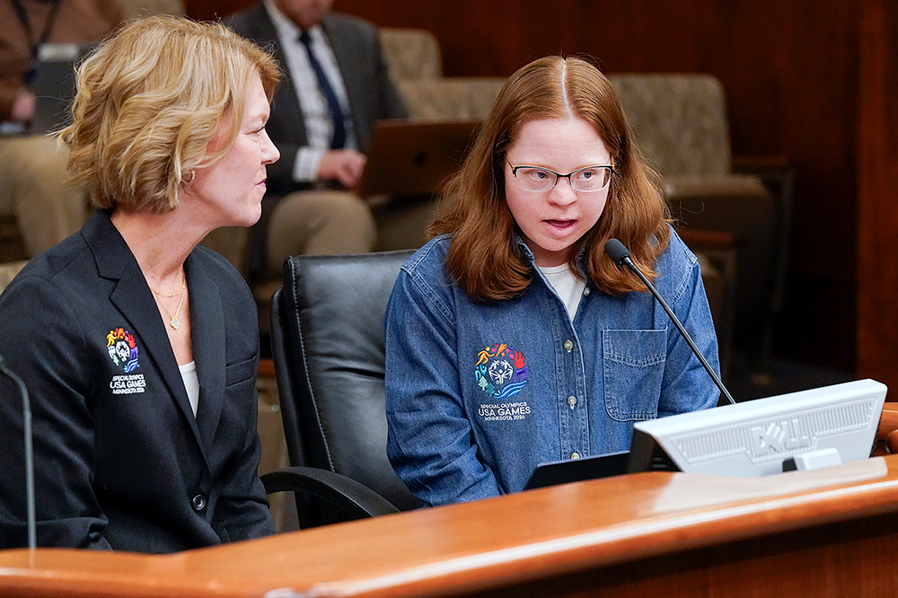 Special Olympics athlete Abby Hirsch testifies before the House economic development panel March 27 in support of HF4123. Christy Sovereign, president and CEO of the 2026 Special Olympics USA Games, left, also testified. Copyright Minnesota House of Representatives. Photo by Michele Jokinen.