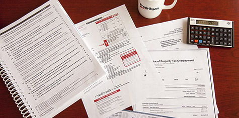 An array of tax forms and booklets laid out on a desk